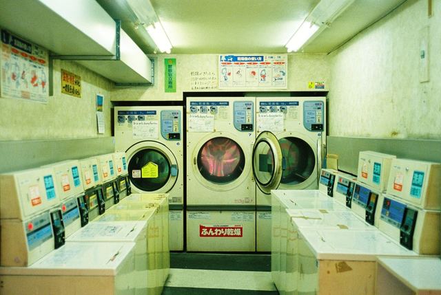 A coin laundry in green light